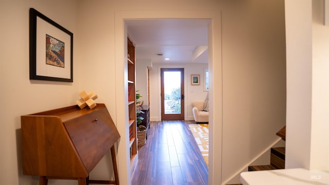 interior space with stairs, baseboards, and wood finished floors