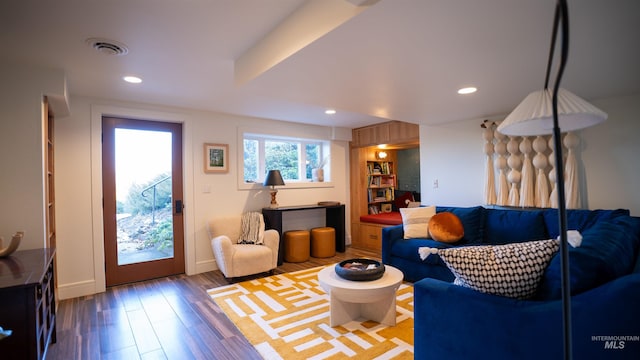 living room featuring wood finished floors, visible vents, and recessed lighting