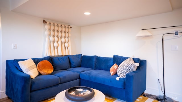 living room featuring baseboards and recessed lighting