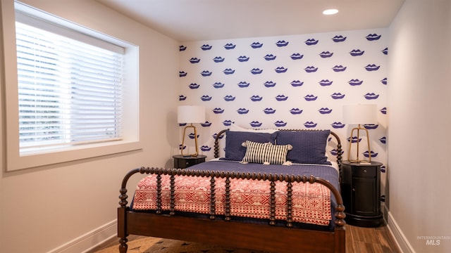 bedroom featuring baseboards and wood finished floors