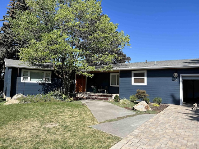 ranch-style house with a garage and a front lawn