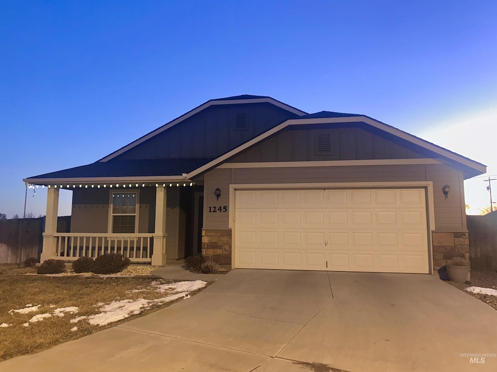 view of front of property featuring a garage and covered porch