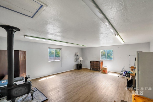 712 Yakima Ave, Filer, ID 83328 - misc room with a wood stove, a textured ceiling, wood finished floors, and baseboards