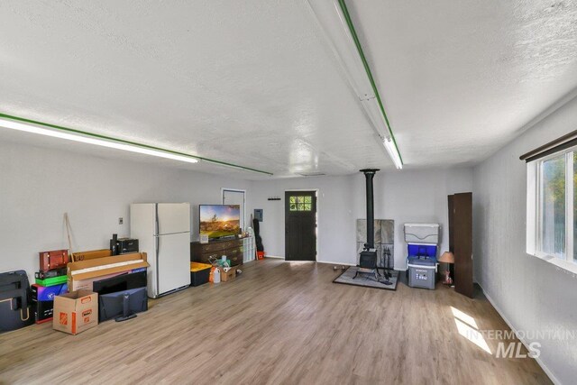 712 Yakima Ave, Filer, ID 83328 - garage with freestanding refrigerator and a wood stove