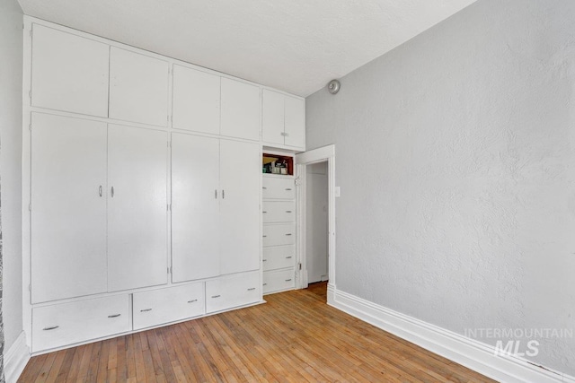 712 Yakima Ave, Filer, ID 83328 - unfurnished bedroom with baseboards and light wood-type flooring