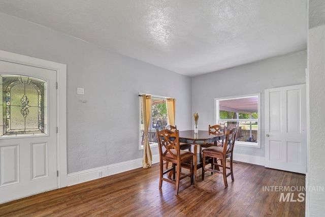 712 Yakima Ave, Filer, ID 83328 - dining area with dark wood finished floors, baseboards, and a textured ceiling