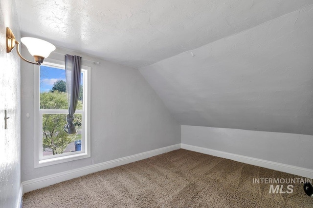 712 Yakima Ave, Filer, ID 83328 - additional living space featuring vaulted ceiling, baseboards, and carpet