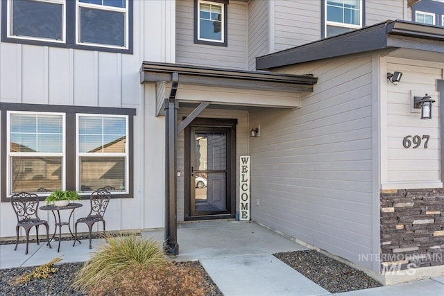 doorway to property featuring board and batten siding