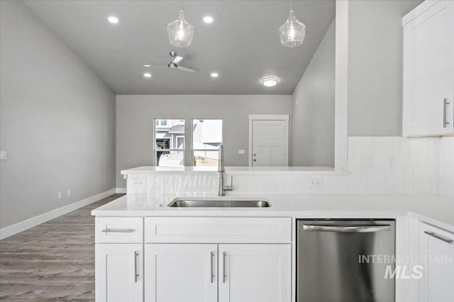 kitchen featuring dishwasher, light countertops, wood finished floors, white cabinetry, and a sink