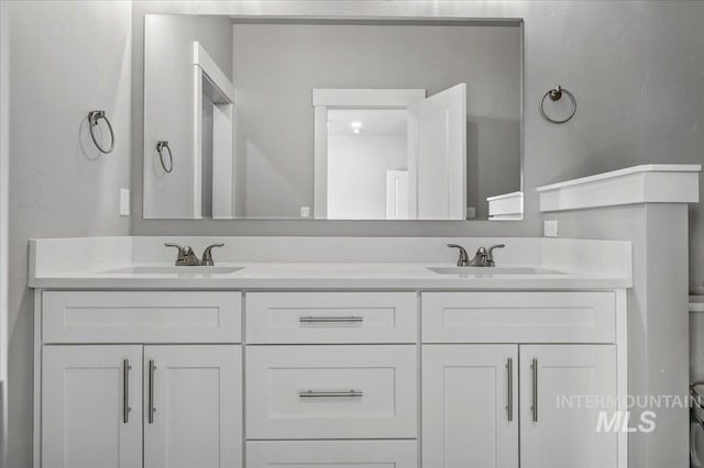 bathroom featuring double vanity and a sink