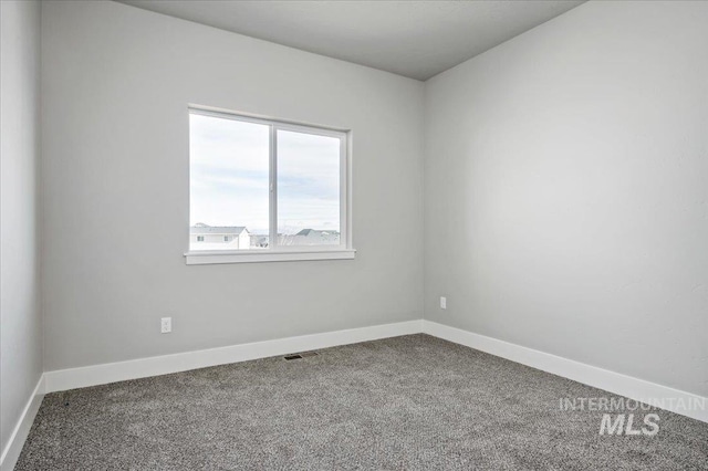 unfurnished room featuring carpet flooring and baseboards