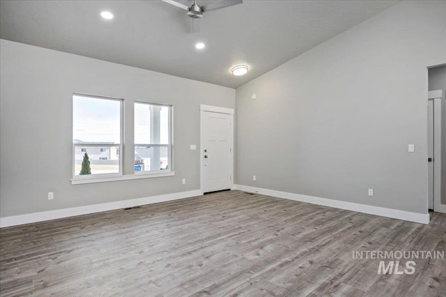 empty room featuring baseboards, wood finished floors, and a ceiling fan