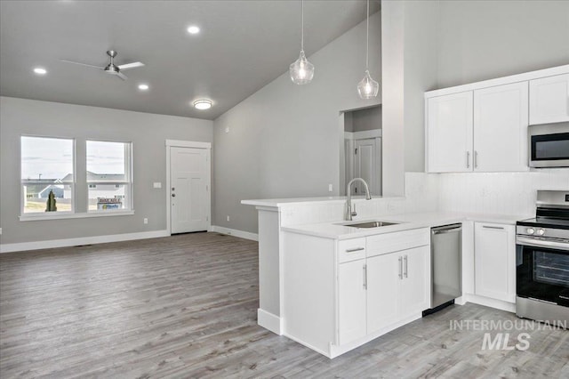 kitchen featuring white cabinetry, stainless steel appliances, ceiling fan, and a sink