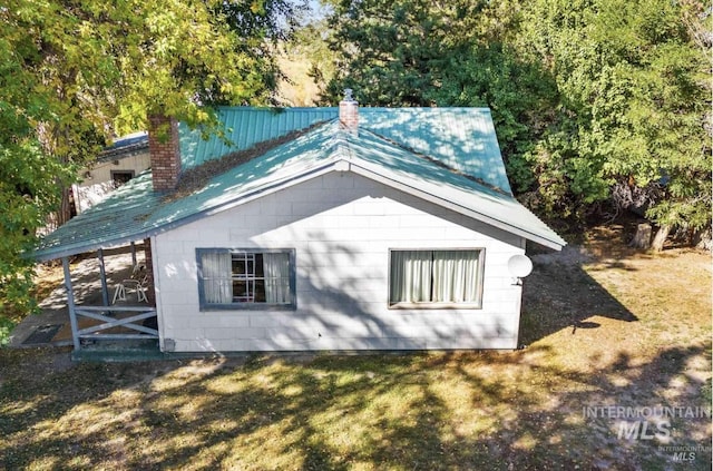 view of side of home with a chimney