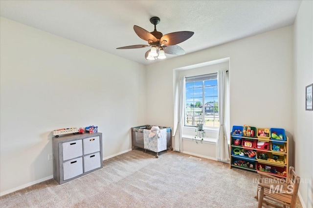 playroom featuring baseboards, a ceiling fan, and carpet flooring