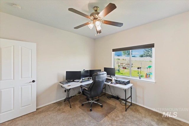 office featuring carpet floors, baseboards, and ceiling fan