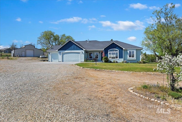 ranch-style house with an attached garage, board and batten siding, driveway, and a front yard