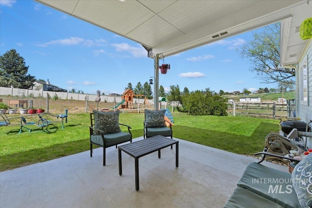 view of patio featuring a playground, a fenced backyard, and visible vents