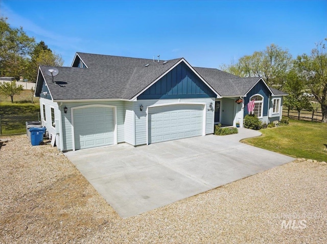 single story home with a garage, a front lawn, fence, board and batten siding, and driveway