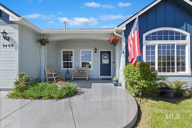 doorway to property with covered porch and board and batten siding
