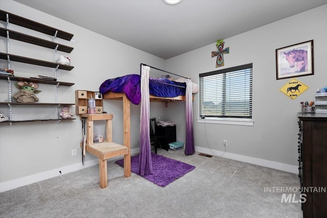 bedroom featuring light colored carpet and baseboards