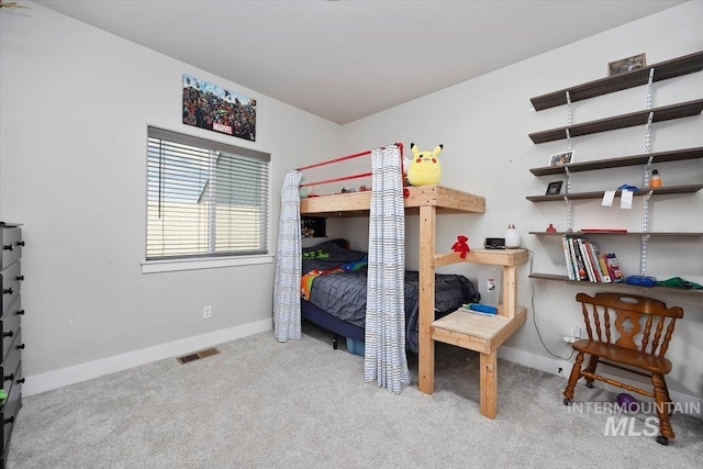 bedroom with visible vents, light carpet, and baseboards