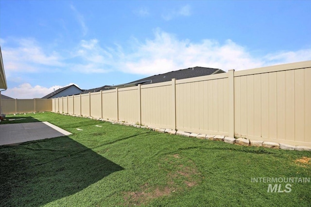 view of yard featuring a patio area and a fenced backyard