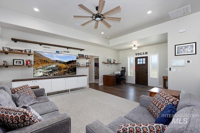 living area with recessed lighting, visible vents, ceiling fan, and wood finished floors