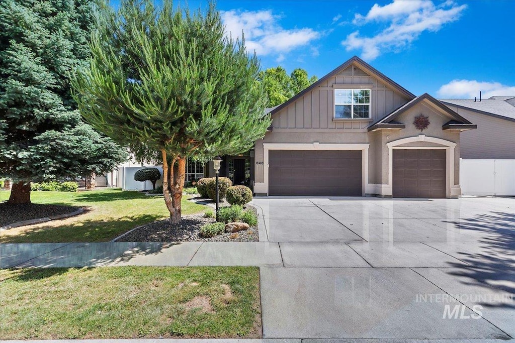 846 E Glacier Bay Ct, Meridian, ID 83642 - view of front of home with a garage, concrete driveway, a front yard, and board and batten siding
