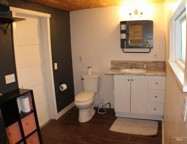 bathroom featuring vanity, tasteful backsplash, wooden ceiling, and toilet