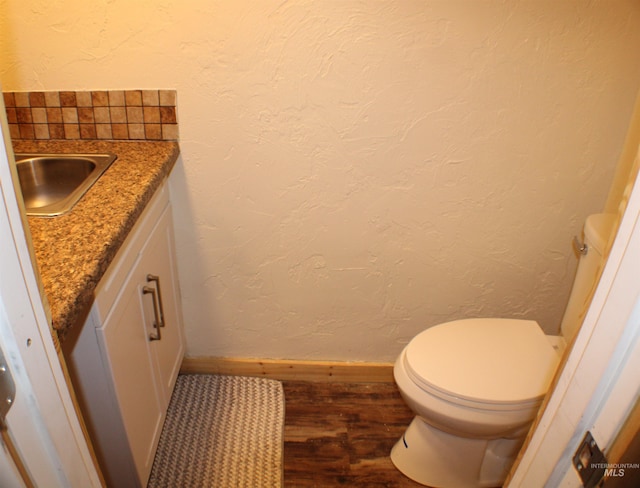 bathroom featuring vanity, hardwood / wood-style floors, and toilet