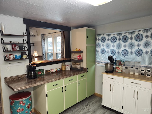 kitchen with green cabinetry and light hardwood / wood-style floors