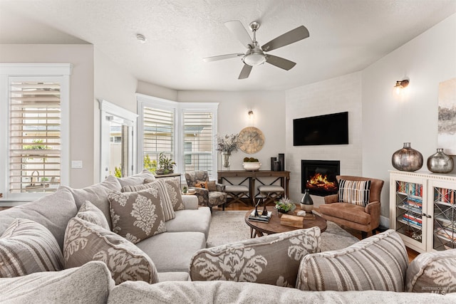 733 W Cowman St, Eagle, ID 83616 - living room with a ceiling fan, a fireplace, and a textured ceiling