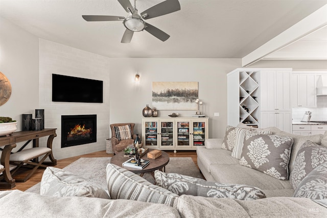 733 W Cowman St, Eagle, ID 83616 - living area featuring a fireplace, a ceiling fan, and wood finished floors
