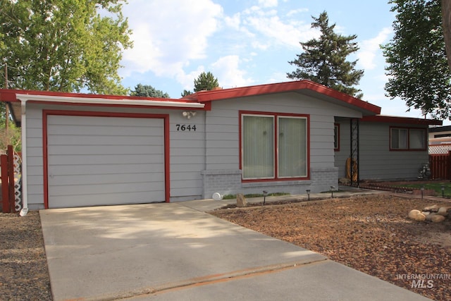 7644 W Cambridge Dr, Boise, ID 83704 - ranch-style house with driveway and an attached garage