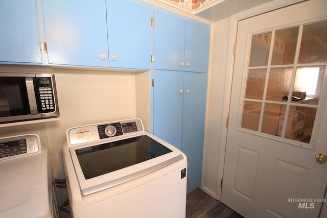 7644 W Cambridge Dr, Boise, ID 83704 - washroom featuring washing machine and dryer, cabinet space, and dark wood-style floors