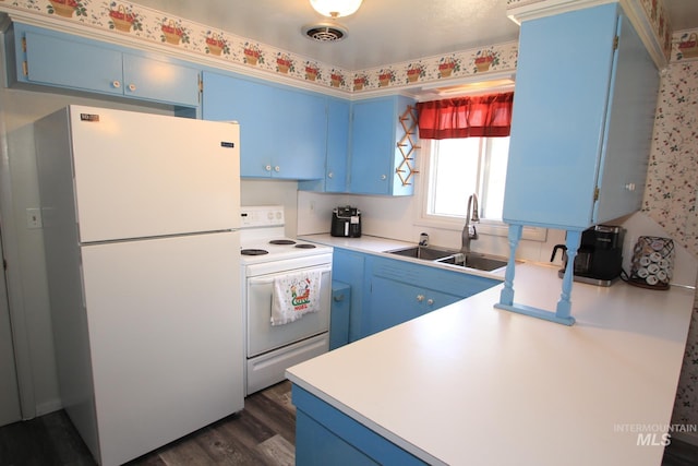 7644 W Cambridge Dr, Boise, ID 83704 - kitchen with white appliances, blue cabinets, light countertops, and dark wood finished floors