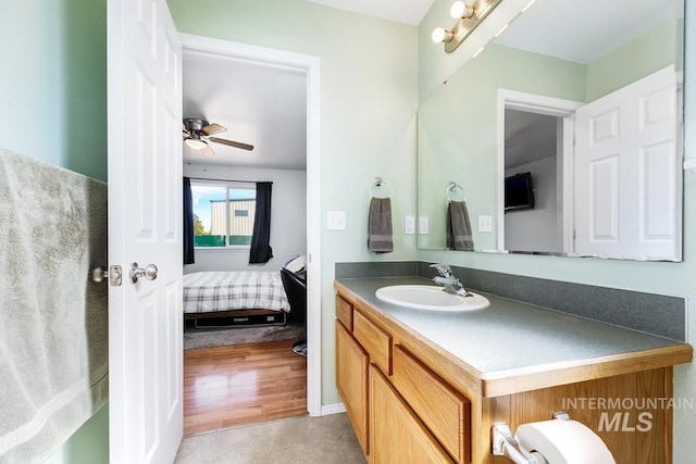 bathroom with ensuite bathroom, ceiling fan, and vanity