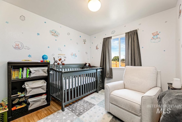 bedroom featuring a crib