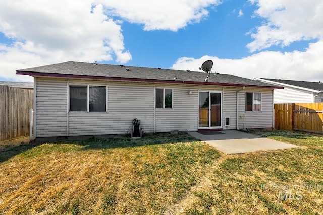 rear view of property featuring a patio area, a fenced backyard, and a lawn