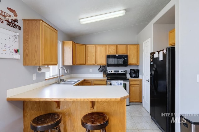 kitchen featuring a sink, light countertops, a peninsula, black appliances, and lofted ceiling