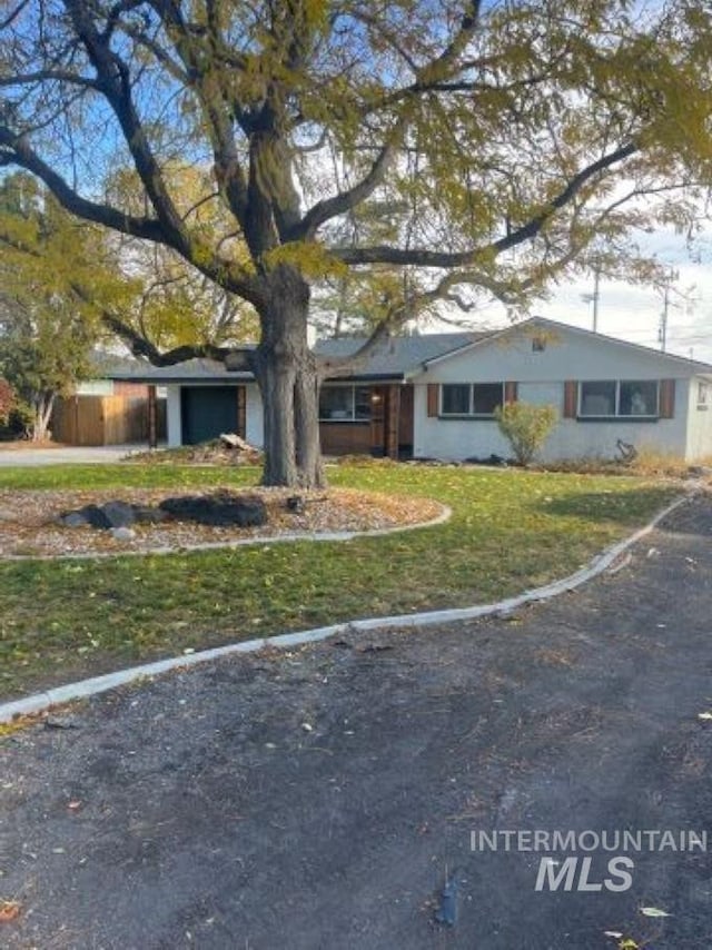 ranch-style home featuring a front yard