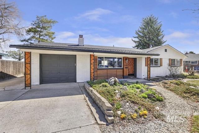 632 Lynwood Blvd, Twin Falls, ID 83301 - ranch-style house featuring concrete driveway, an attached garage, a chimney, and brick siding