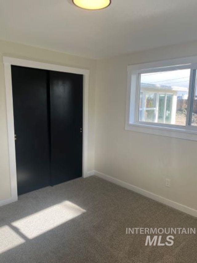 unfurnished bedroom with carpet and a closet