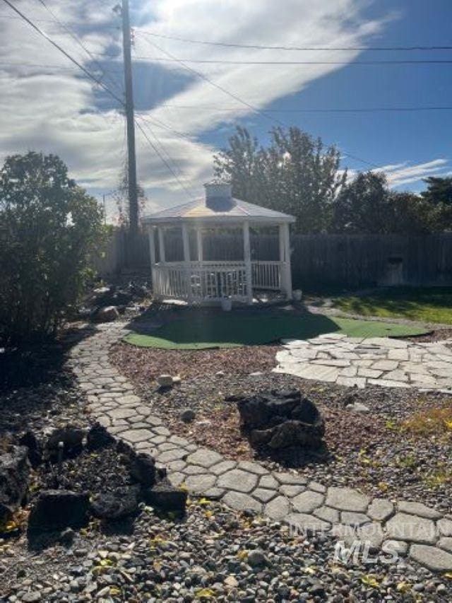 rear view of property featuring a gazebo