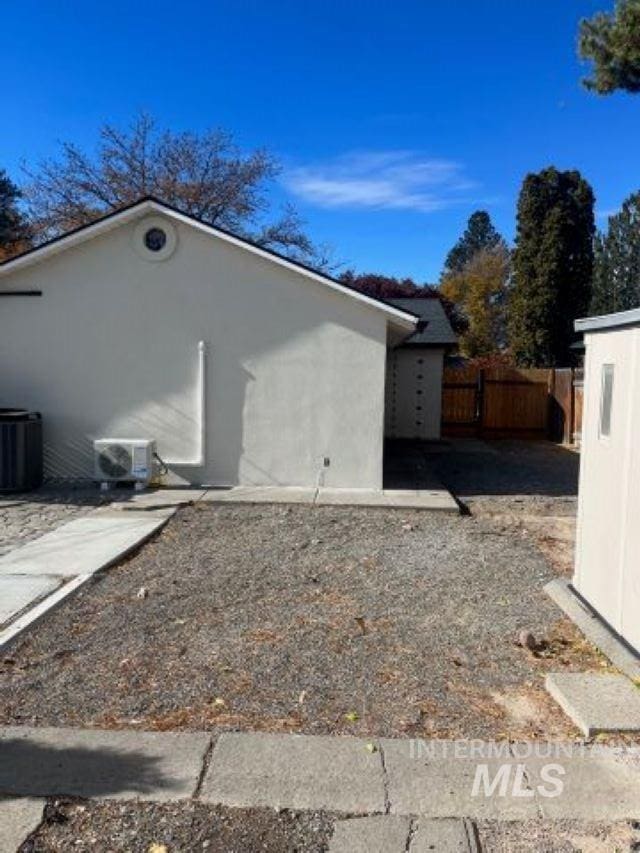 view of side of property with central air condition unit