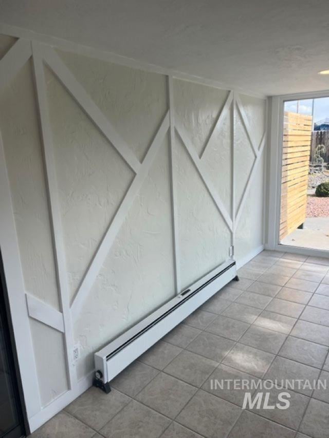 interior space featuring tile patterned floors and baseboard heating