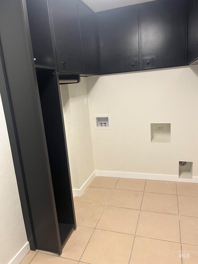 washroom with washer hookup, cabinets, electric dryer hookup, and light tile patterned flooring