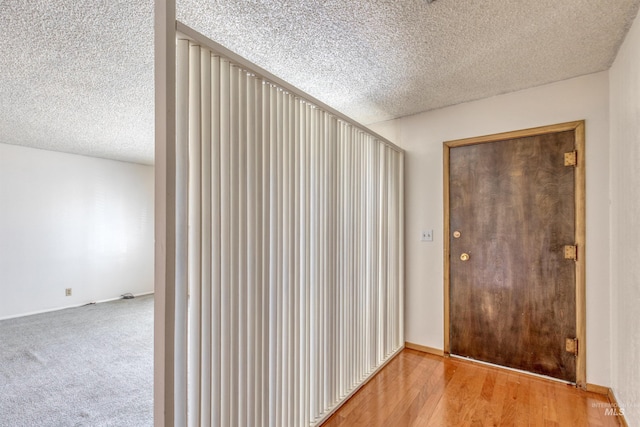 entryway featuring a textured ceiling and wood finished floors