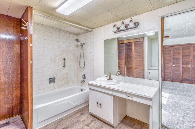 full bathroom with visible vents, bathing tub / shower combination, vanity, and wood finished floors